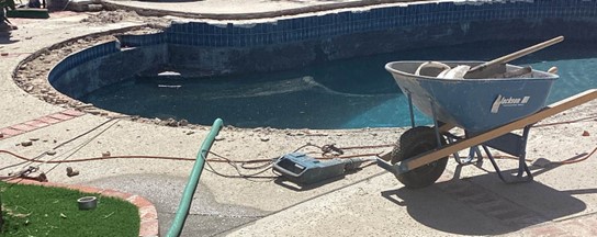 outdoor pool with maintenance equipment on pool deck