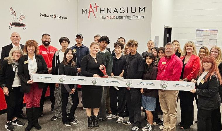 Large group cutting a ribbon inside the newly opened Mathnasium Simi Hills location