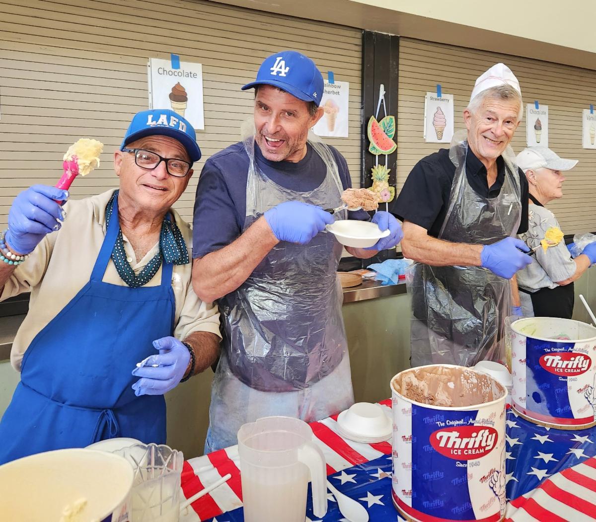 Three volunteers serving ice cream at the Senior Center