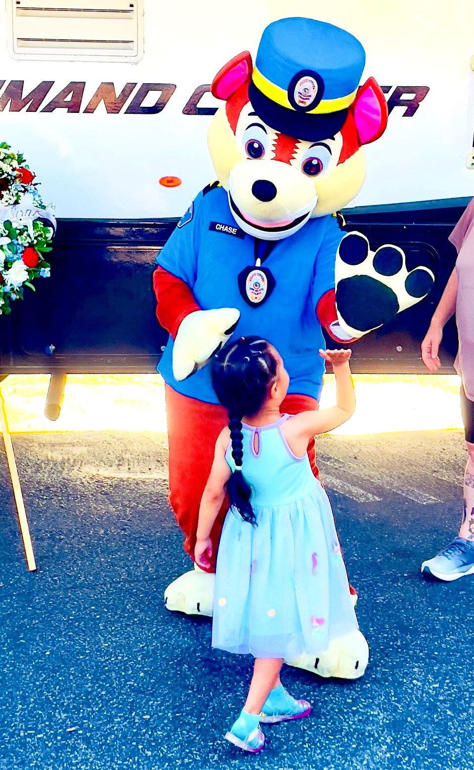 MacGruff mascot high fiving a little girl