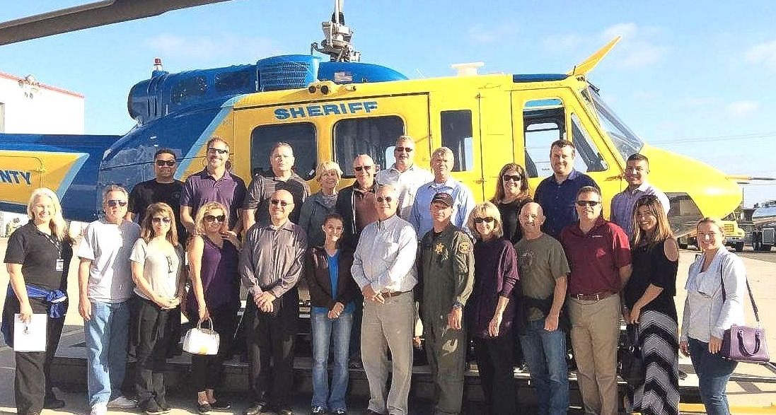 Large group of Citizens Police Academy students standing in front of a helicopter