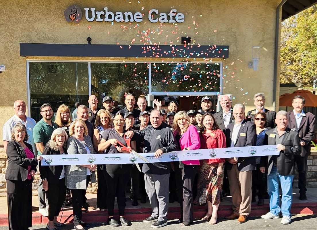 Large group cutting a ribbon in front of newly opened Urbane Cafe in Simi ValleyAction Drug Rehab Center