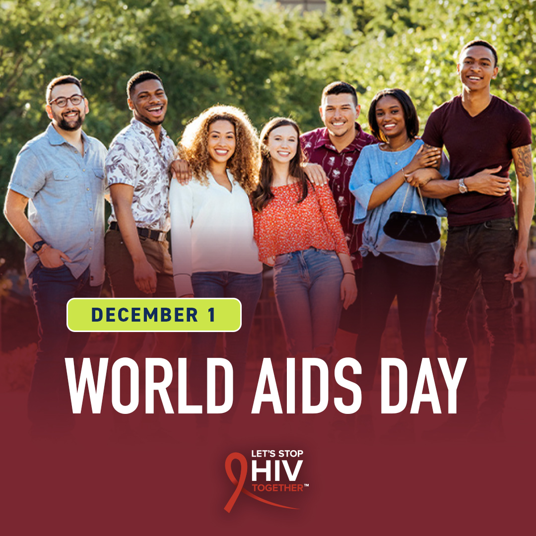 Seven people posing and smiling outdoors with the text December 1 World AIDS Day below