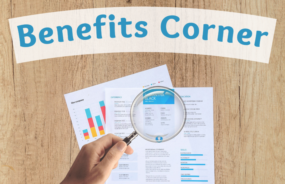 Magnifying glass being held over documents containing graphs and text below the words Benefits Corner in bold blue text and wood table background
