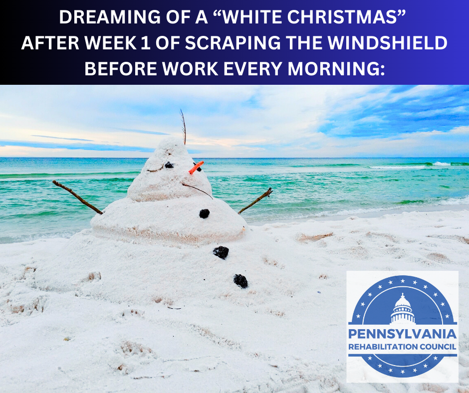 Melting Snowman made out of sand on a beach with the ocean waves in the background
