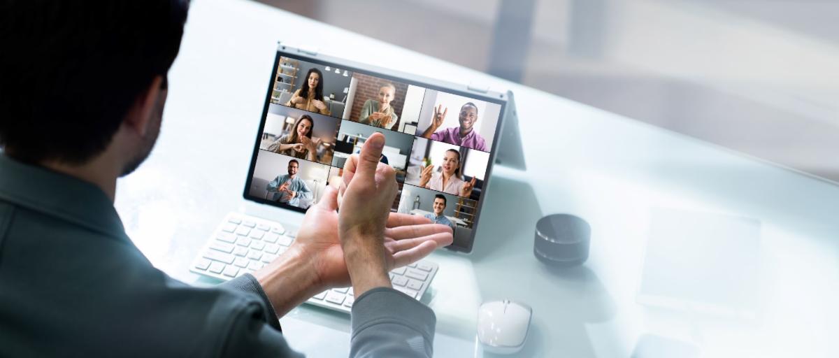 Person using sign language during a virtual meeting on their laptop