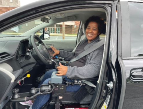 Tanara smiles for a photo while sitting in her modified van