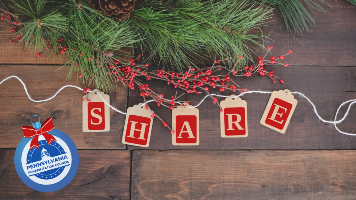 Ornaments on a wooden table spelling out the word SHARE in red with pine needles holly berries string and the PaRC logo on a tree ornament decorating the table