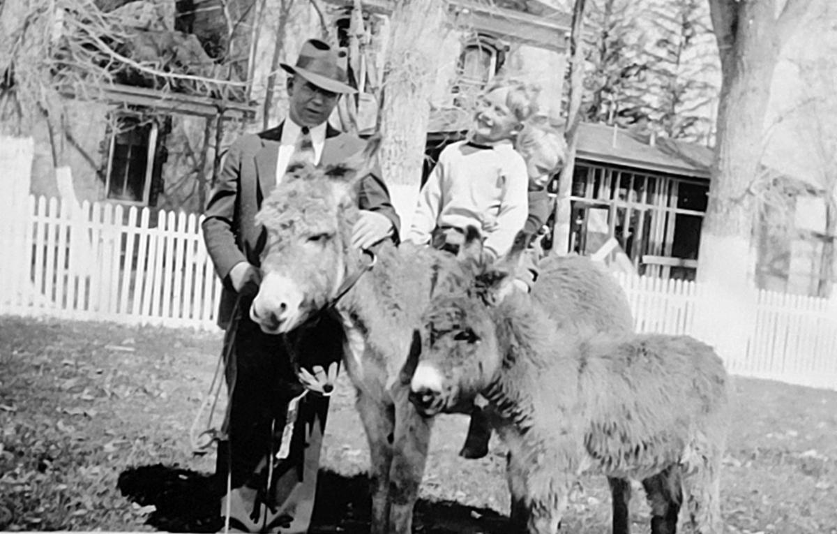 Mr. F.M. Young and kids on burros