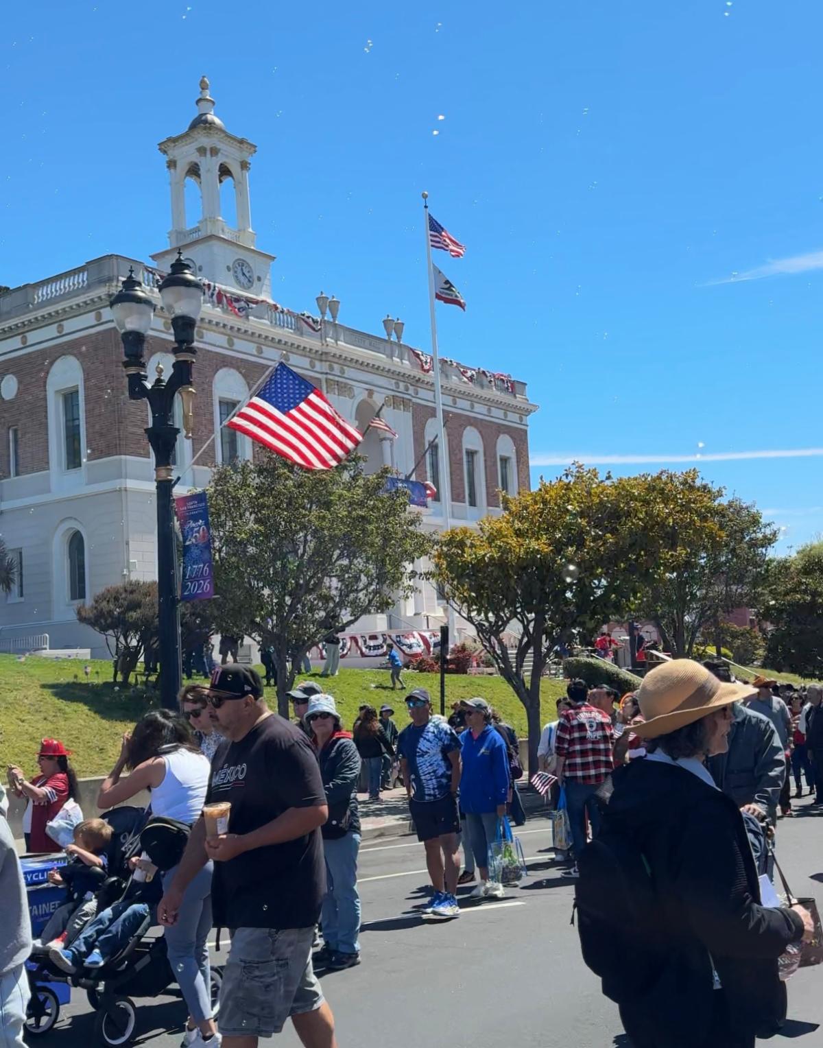 people on the street in front of City Hall