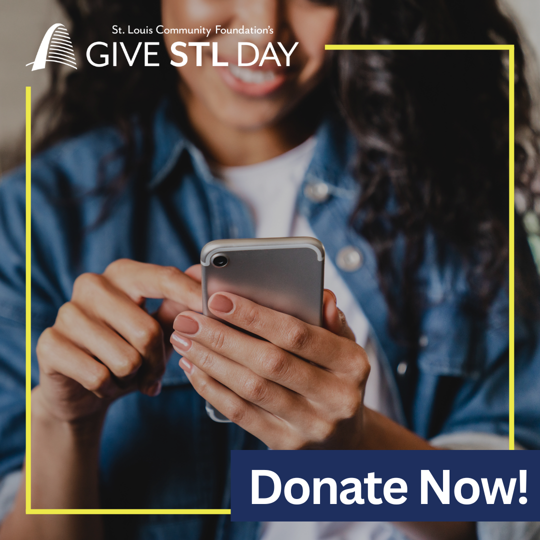Person holding and tapping a smartphone, framed by yellow lines, with text reading ‘Give STL Day’ and ‘Donate Now.
