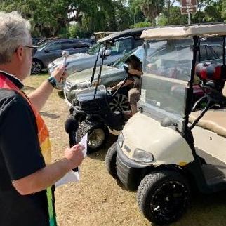 Priest blesses the golf carts