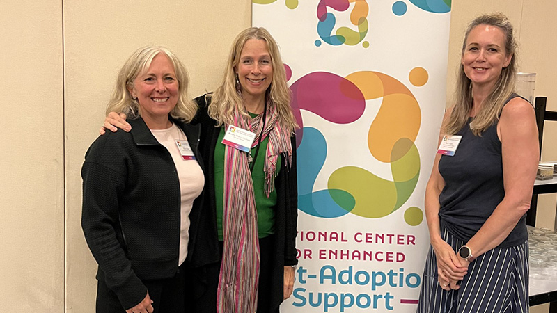ORPARC and colleagues from the Oregon Department of Human Services in from of the National Center for Enhanced Post-Adoption Support banner