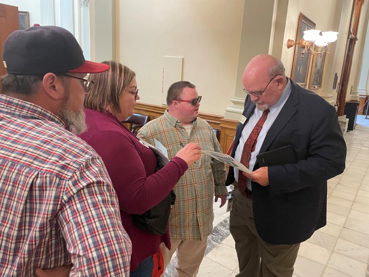 Rep Steve Tarbin speaks with the St. Pierre family about waivers and wages