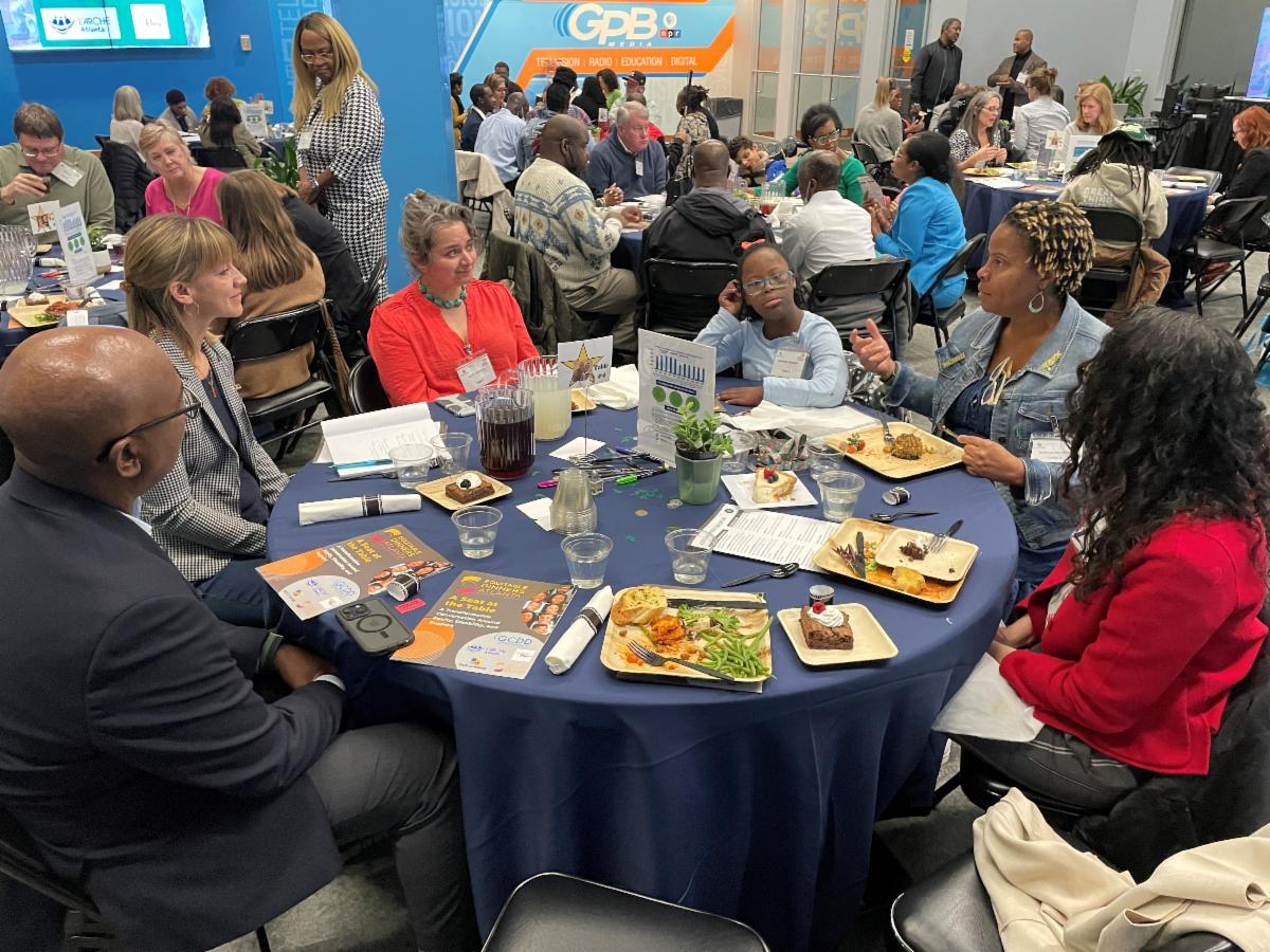 People sit around a table for a discussion