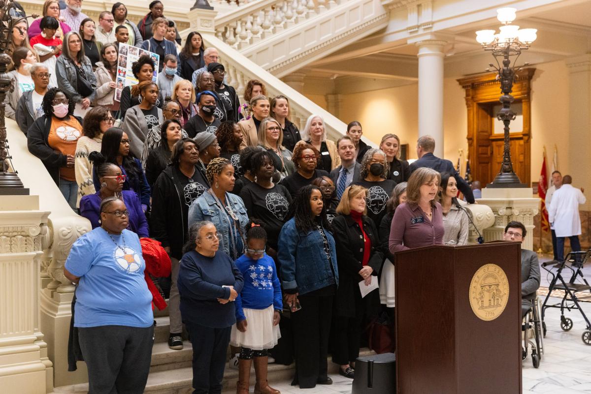 Senator Sally Harrell speaks to the media as she stands in front of disability advocates.