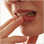 Extreme close-up of a woman biting her lip