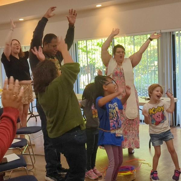 multi-generational group is actively silly during worship