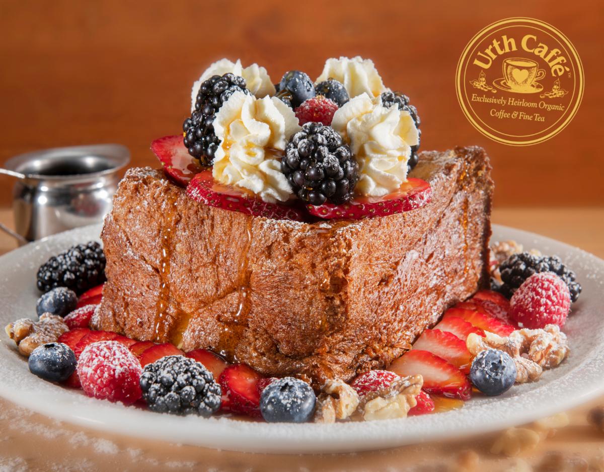 Photo of Urth Caffé French Toast King™, with berries and whipped cream on a white plate.