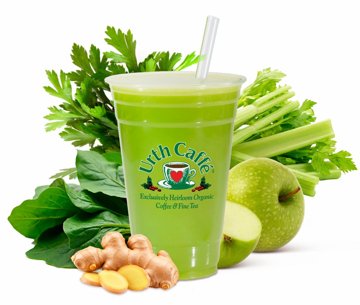 Photo of Urth Caffé Green juice in a togo cup with spinach, celery, parsley, apple and ginger in the background..