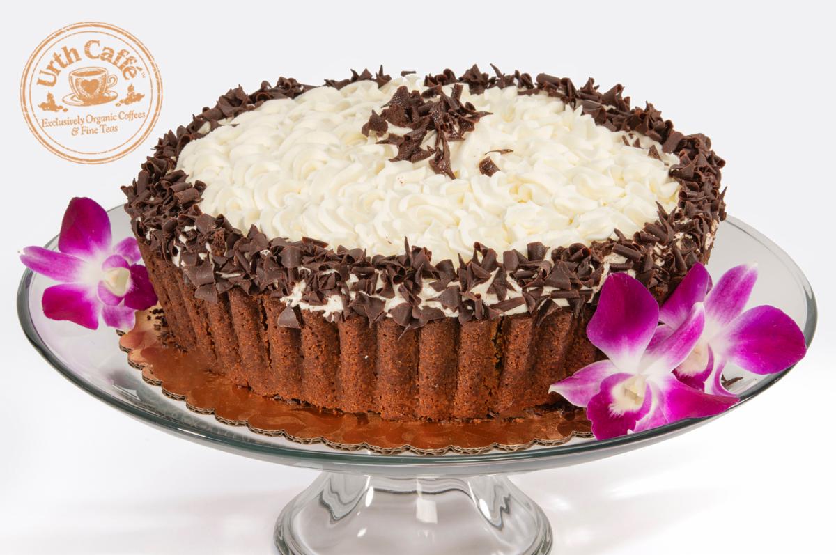Photo of a whole Urth Caffé Banana Cream Pie on a cake stand and white background, with Urth logo.