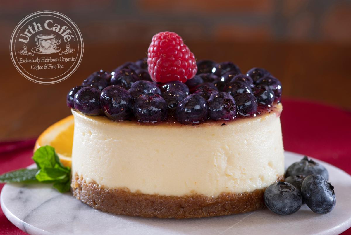 Photo of Urth Caffé Blueberry Cheesecake on a plate with garnish and Urth logo.