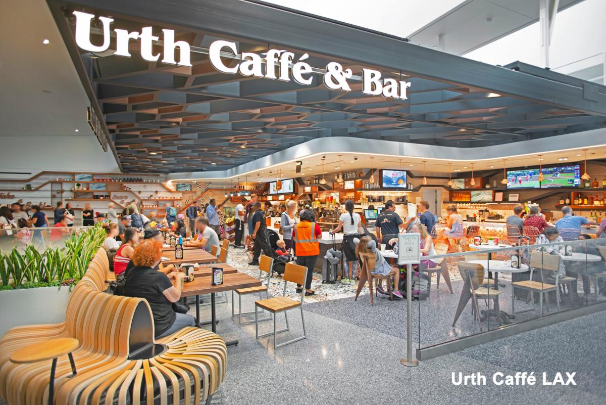 Photo of Urth Caffé LAX Interior with guest, sitting at tables, sitting at the bar and waiting in line to place order.