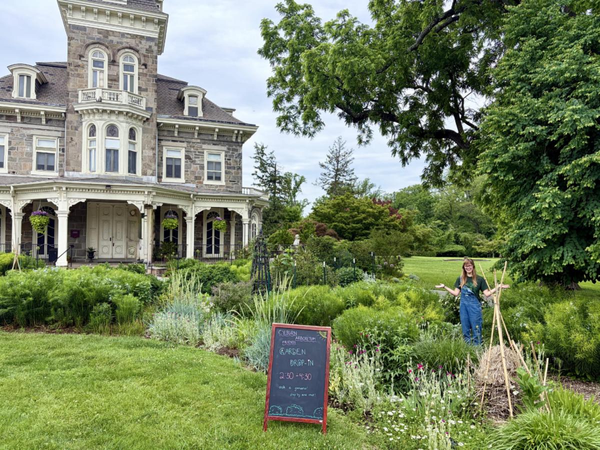 Woman standing in a garden outside of Cylburn mansion
