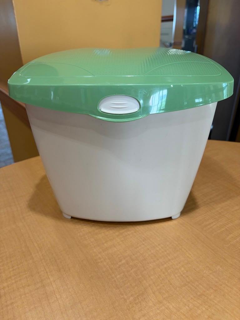 Image of a small compost bin with a white bottom and a green lid. 