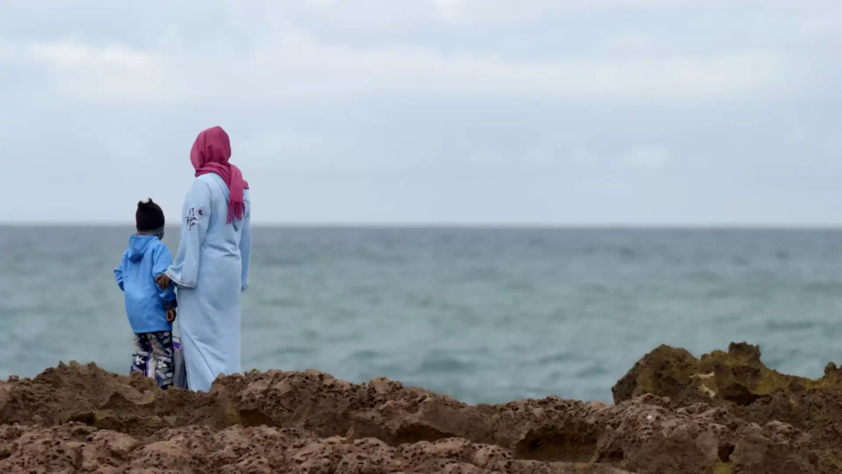 people standing by body of water