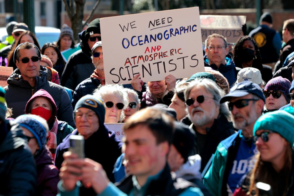 scientists at event with signs