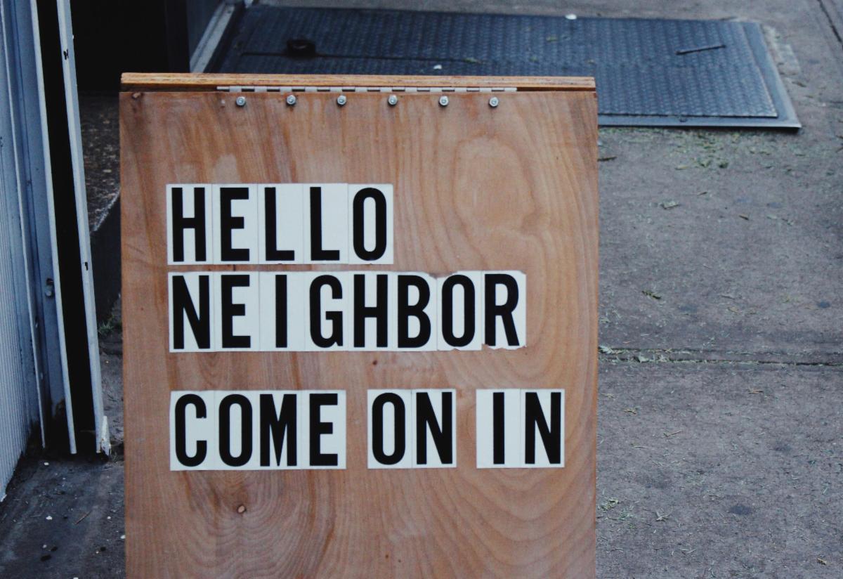 A sign with letters spelling Hello Neighbor Come on In