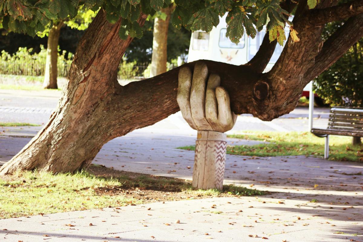 Tree supported by a giant hand