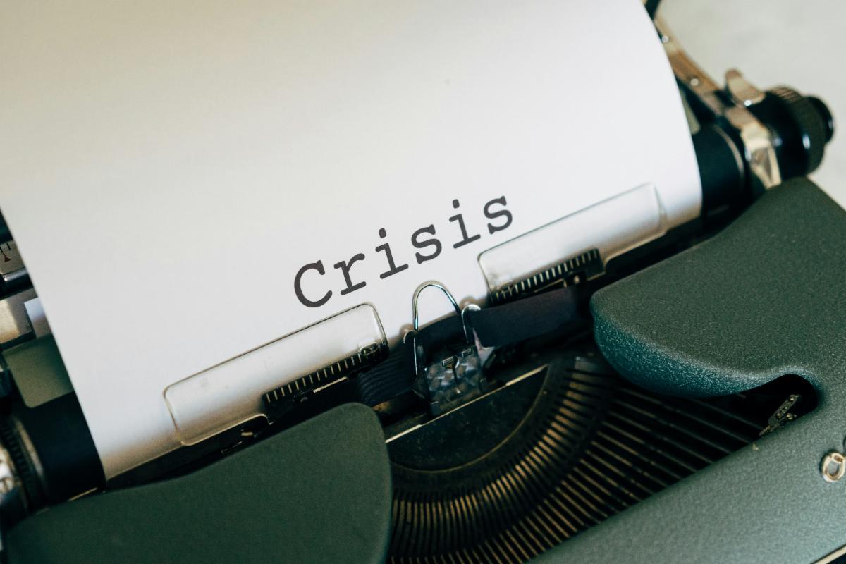 The word Crisis on a page in a typewriter