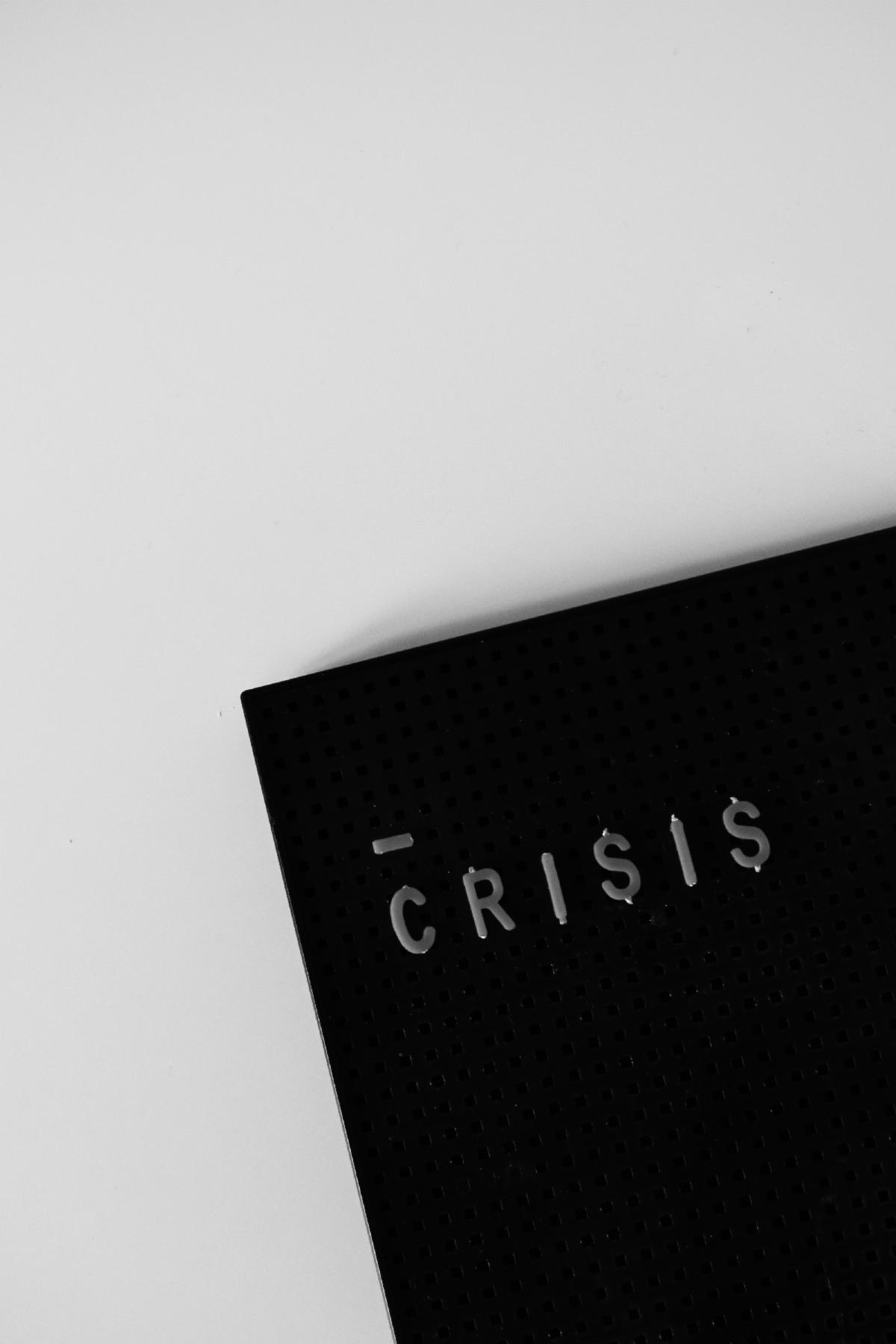 The word Crisis on a black book with a white background