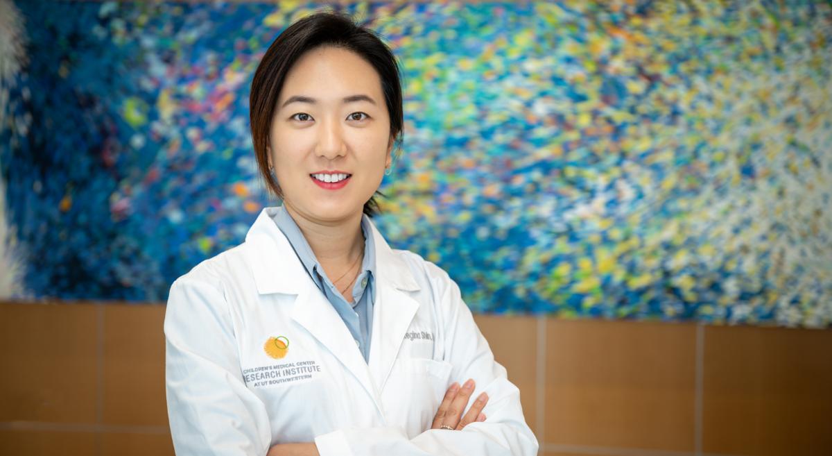 Headshot of Children's Medical Center Research Institute at UT Southwestern Assistant Professor Hijai Regina Shin, Ph.D., with her arms folded. 