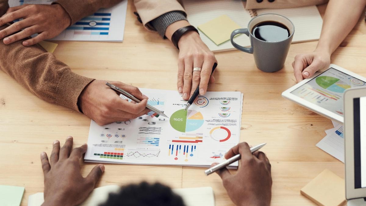 A group of people around a table writing a business plan