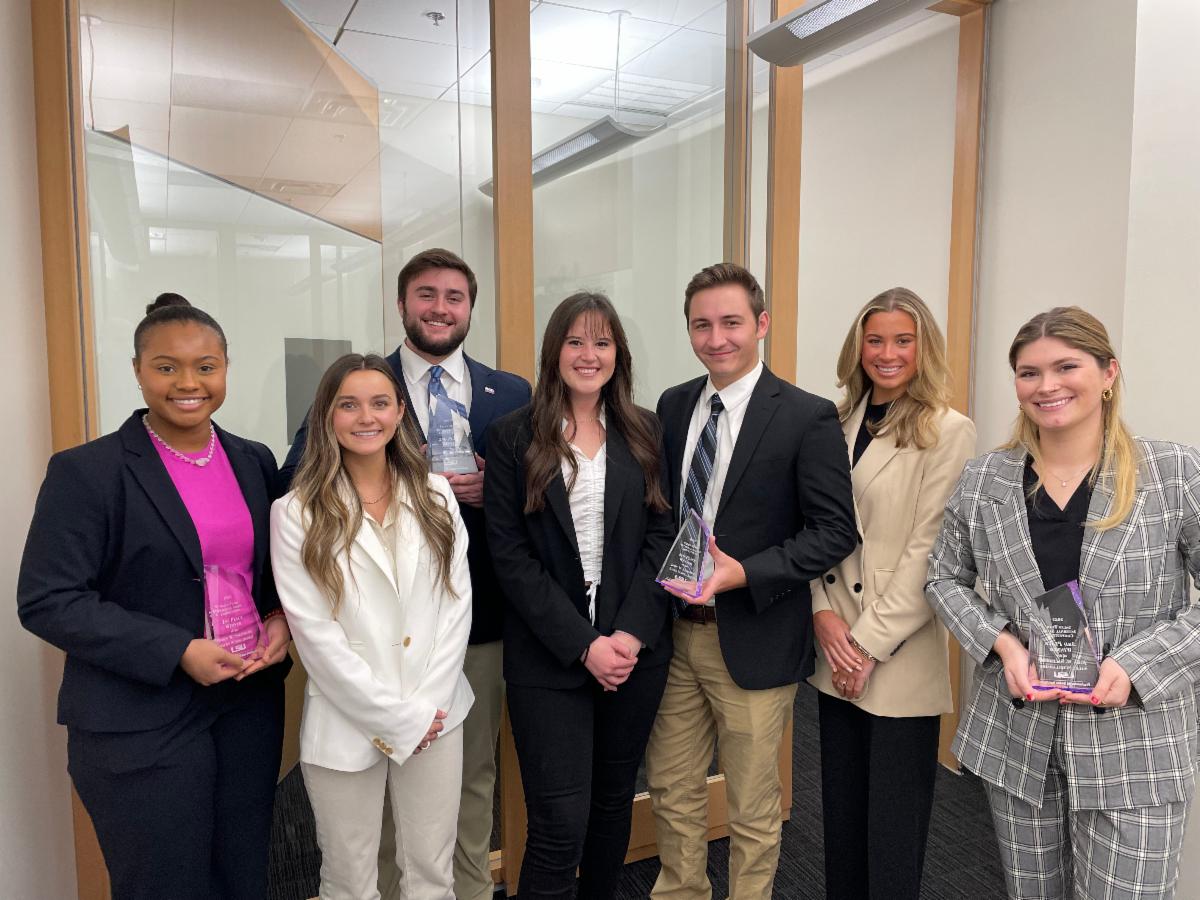 Sales Team holds trophies after an internal competition