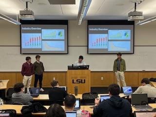 Students give a VCAP presentation in a classroom.