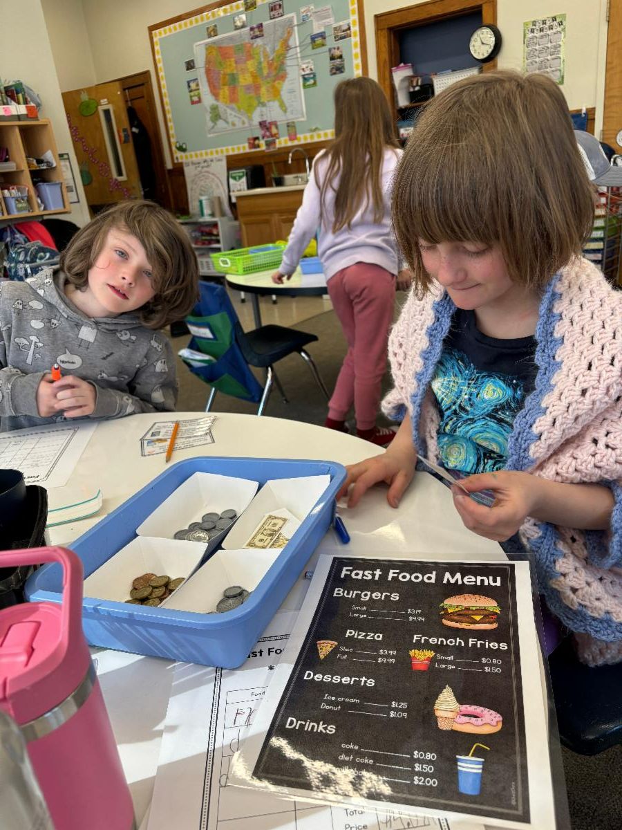 2nd grade students learn about money by operating a pretend store
