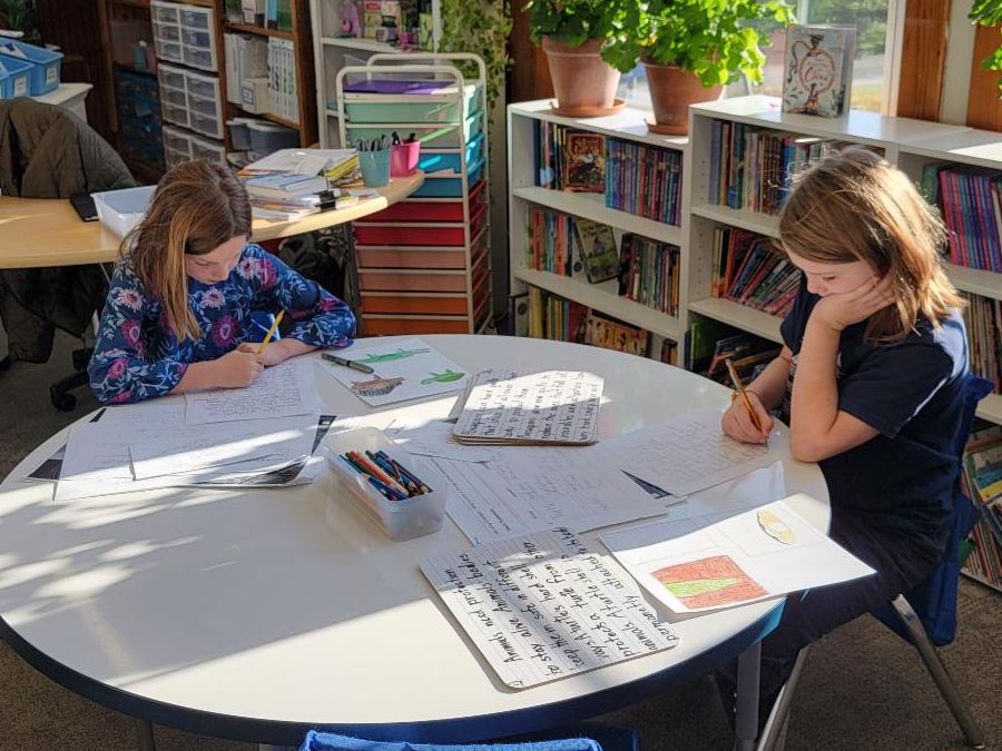 Third graders work on a writing piece in a sunny classroom