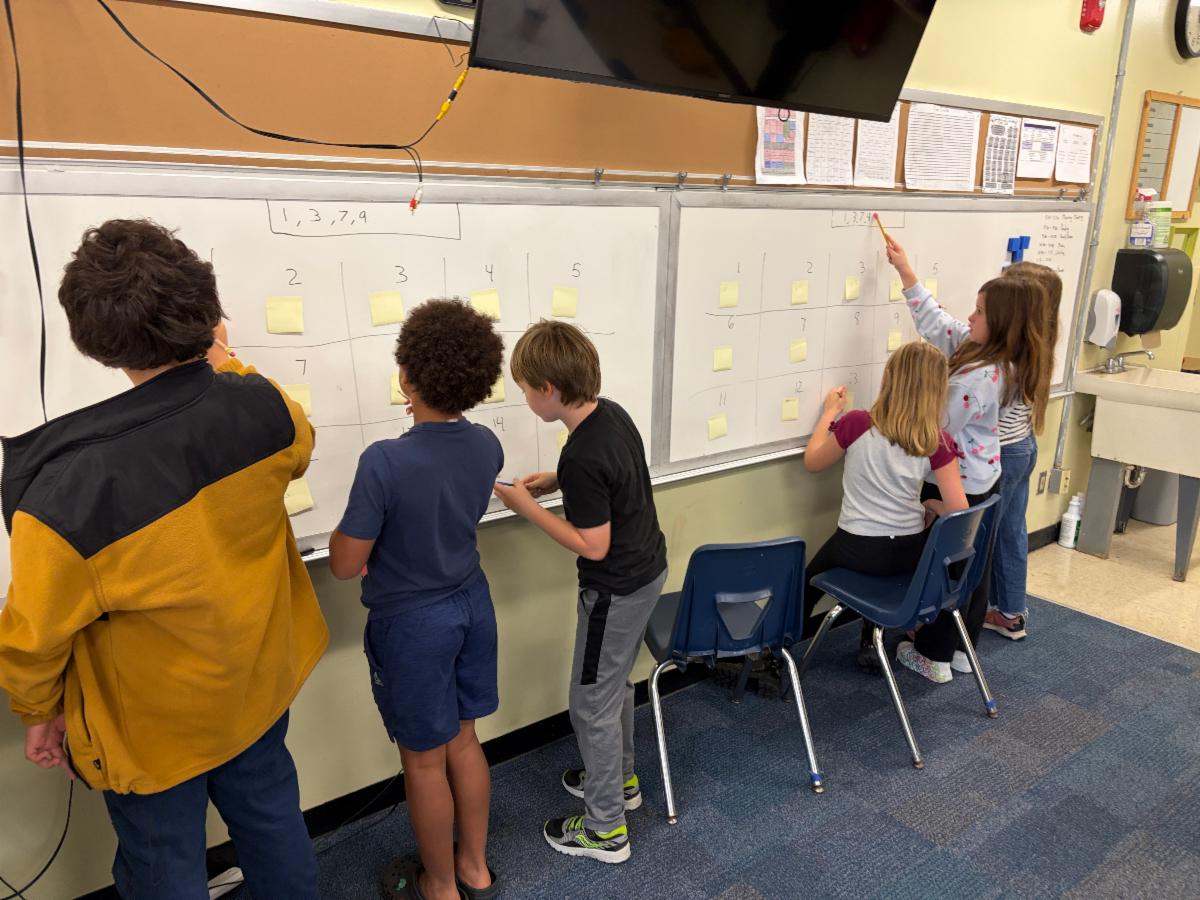 Fourth graders working at the board