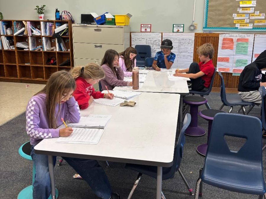 Fourth graders work on writing pieces
