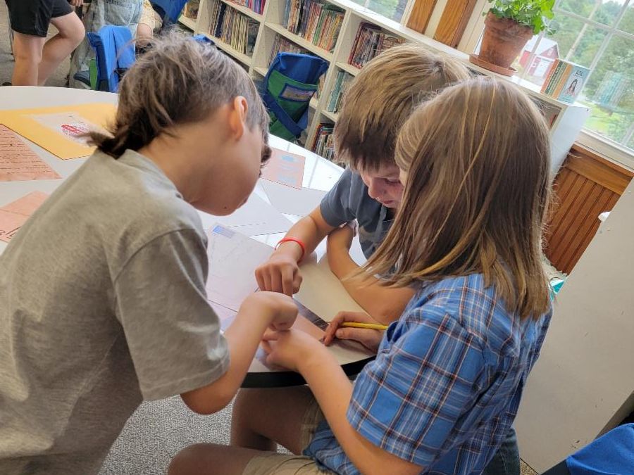 Third graders work together to solve an escape room