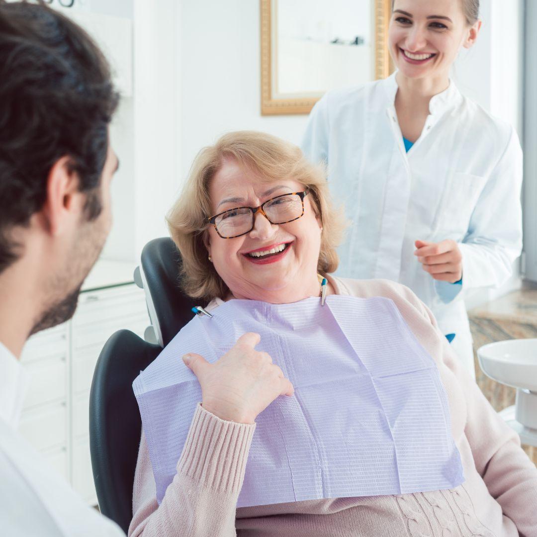 Woman smiling in a dental chair.
