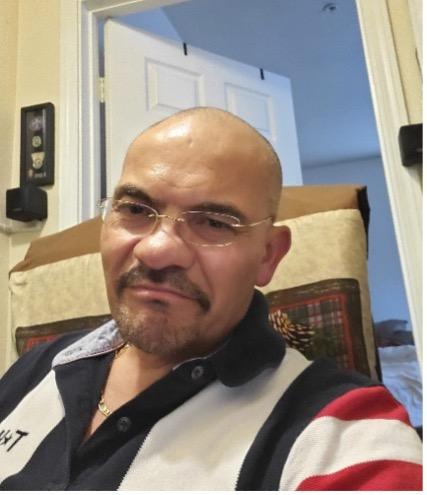 Photo of Francisco Sanchez sitting in a chair 