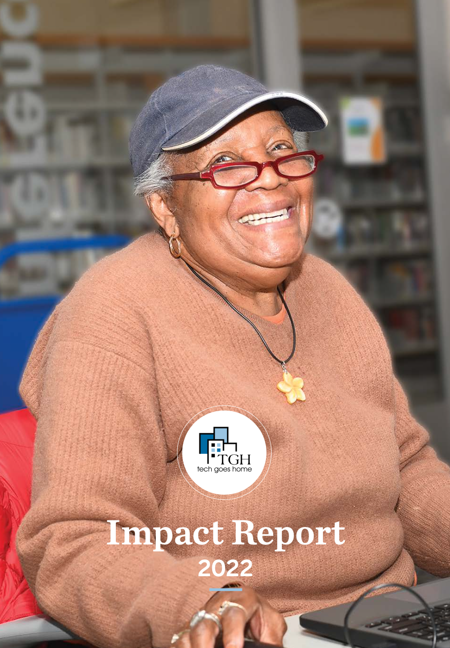 Text reads Impact Report 2022. Image shows a woman smiling while working on her computer.