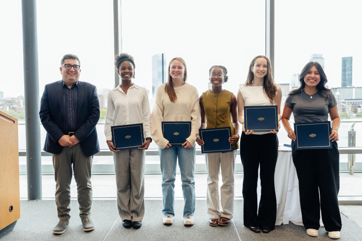 Five undergraduate students accepting an award from Department Head Ali Jadbabaie.