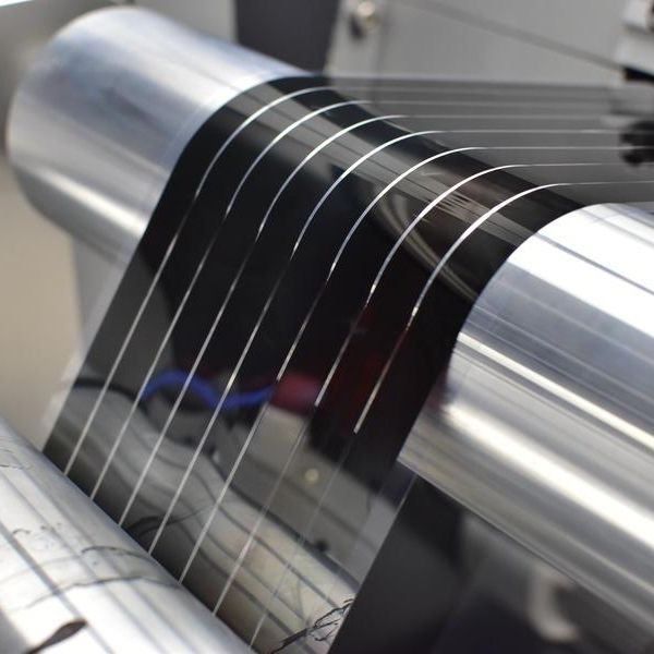 Photo of a flexible solar film being fabricated on a roll-to-roll printer.