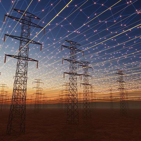Solar panels and wind turbines connected by grid lines.